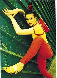 Images Dated 14th June 1995: Female model wearing red denims - D & F general fashion - climbing wooden fence