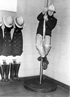 Firefighter Geoff Kelly slides down the pole at Consett Fire Station Firefighter Geoff Kelly slides down the pole at Consett Fire Station