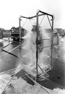 Firefighters are decontaminated after dealing with the chemical spillage at the scene Firefighters are decontaminated after dealing with the chemical spillage at the scene