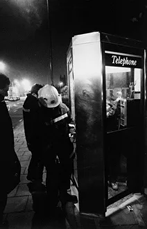 Firefighters free a youngter from a telephhone box jammed shut by his friends Firefighters free a youngter from a telephhone box jammed shut by his friends