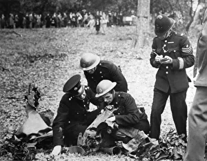 A fireman reading the wording on the remains of a bomb to a police officer who takes A fireman reading the wording on the remains of a bomb to a police officer who takes