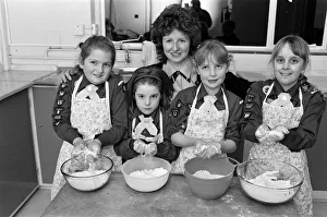 Flour power... Brownie helper Diane Felton shows these members of St Francis' Flour power... Brownie helper Diane Felton shows these members of St Francis'
