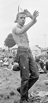 Flower Power festival at Woburn Abbey, August 1967 A hippy dressed with feathers in Flower Power festival at Woburn Abbey, August 1967 A hippy dressed with feathers in