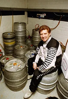 Football player and manager Alan Ball sitting on a barrell in the cellar of his new pub Football player and manager Alan Ball sitting on a barrell in the cellar of his new pub