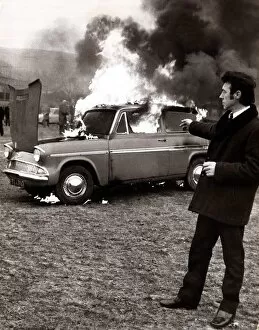 Images Dated 5th January 1971: Ford - Motor Cars George Terrace sets fire to his car to draw attention to shoddy