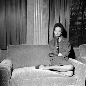 French film actress Capucine poses sitting on a sofa at the Odeon in Leicester Square French film actress Capucine poses sitting on a sofa at the Odeon in Leicester Square