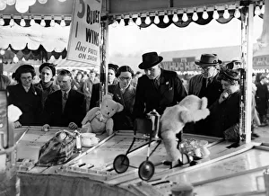 Fun seekers try their skill at one of the sideshows at the Hoppings fair Fun seekers try their skill at one of the sideshows at the Hoppings fair