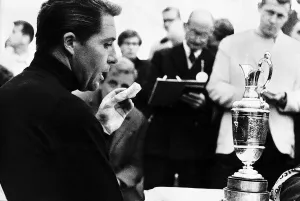 Gary Player eats a banana and contemplates the trophy he has just won at the British Golf Gary Player eats a banana and contemplates the trophy he has just won at the British Golf