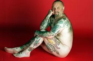 Images Dated 27th April 1997: Gavin Boyra - Tattoo man sitting on floor naked tattoos on legs arms and back. April 1997