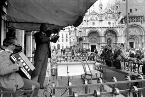 General scenes in Venice. Fiddling while Venice sinks. Signor Ninor Brunello leads a General scenes in Venice. Fiddling while Venice sinks. Signor Ninor Brunello leads a