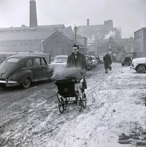 A gentleman wheels his sack of coal back from the coal merchant January 1963 The winter A gentleman wheels his sack of coal back from the coal merchant January 1963 The winter