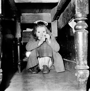 Girl hiding under her table. February 1953 D621 Girl hiding under her table. February 1953 D621
