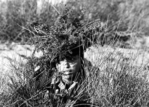 A girl of the Israeli Army in camouflage during basic training A girl of the Israeli Army in camouflage during basic training