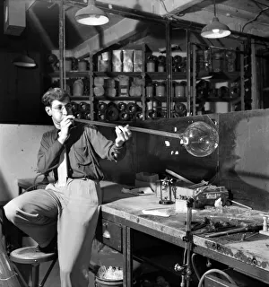 Glass blower Man blowing glass in his workshop. October 1952 C4910 Glass blower Man blowing glass in his workshop. October 1952 C4910