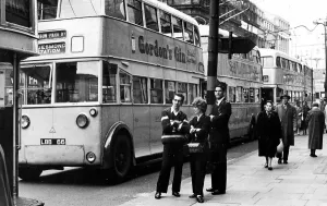 A good time for a chat when trolley bus drivers and a conductress take a break as A good time for a chat when trolley bus drivers and a conductress take a break as