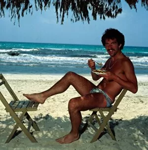 Images Dated 1st June 1978: Graeme Souness sitting at the beach in Majorca eating food, 1978