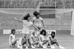 A group of model girls, known as The Exhibitionists, are training for a 5-a-side football A group of model girls, known as The Exhibitionists, are training for a 5-a-side football
