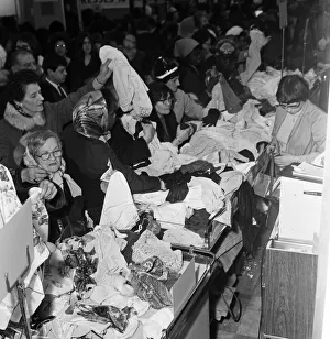 A group of women round one the counters at C&A on Oxford Street trying to snap up a A group of women round one the counters at C&A on Oxford Street trying to snap up a