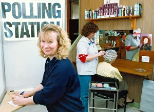 One of the hairdressers casting her vote at the polling station in her salon while staff One of the hairdressers casting her vote at the polling station in her salon while staff