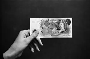 Images Dated 14th February 1974: A hand holding a pound note. 14th February 1974