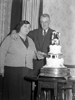 Images Dated 26th October 2005: The happy couple cut the wedding cake at the reception 1949