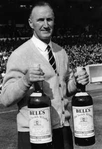 Harris John, Manager Sheffield United FC. holds two giant bottles of Bells whisky Harris John, Manager Sheffield United FC. holds two giant bottles of Bells whisky