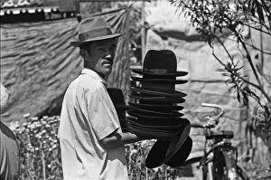 Hat seller at the flower market in Saigon on the eve of the Tet celebrations Hat seller at the flower market in Saigon on the eve of the Tet celebrations