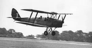 A de Havilland Tiger Moth landing on an airfiield. 02/07/1977 A de Havilland Tiger Moth landing on an airfiield. 02/07/1977