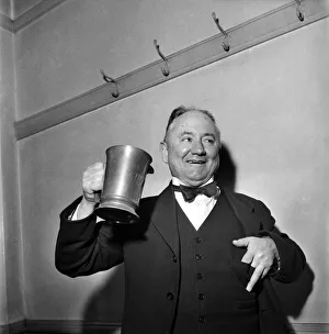 Hector Hughes, Q. C. Labour M. P. for Aberdeen North enjoys a tankard of Inn Coope beer Hector Hughes, Q. C. Labour M. P. for Aberdeen North enjoys a tankard of Inn Coope beer