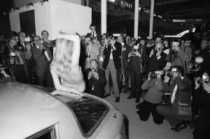 Helen Jones posing topless and drawing the attention of photographers to the TVR stand at Helen Jones posing topless and drawing the attention of photographers to the TVR stand at
