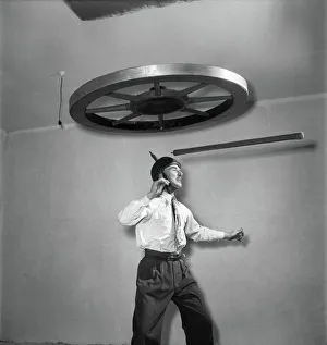 Henri Vadden holds an 80lb cartwheel on a pole which he then places on his chin Henri Vadden holds an 80lb cartwheel on a pole which he then places on his chin