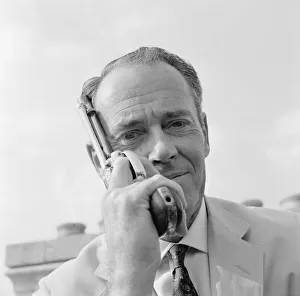 Henry Fonda at the roof of a Television House, holding a revolver next to his face Henry Fonda at the roof of a Television House, holding a revolver next to his face