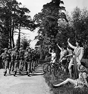 Home Guard volunteers are cheered by local residents sitting on the side of the road as Home Guard volunteers are cheered by local residents sitting on the side of the road as