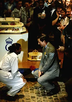 HRH Prince Charles and member of the crowd looking at a birthday cake in Birmingham HRH Prince Charles and member of the crowd looking at a birthday cake in Birmingham