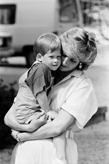 Images Dated 9th August 1987: HRH Princess Diana, The Princess of Wales holds her young son Prince Harry on holiday in