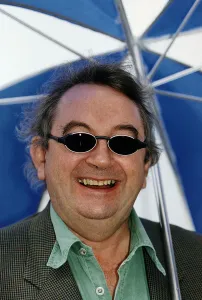 Ian McCaskill wearing a pair of BHS Ultraviolet Protection Sunglasses holding umbrella Ian McCaskill wearing a pair of BHS Ultraviolet Protection Sunglasses holding umbrella