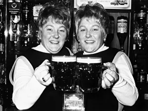 Identical twin barmaids Joan Metcalf and Marie Dunn seen here behind the bar 1977 Identical twin barmaids Joan Metcalf and Marie Dunn seen here behind the bar 1977
