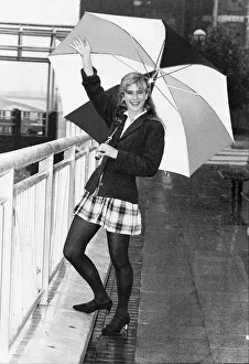 Imogen Stubbs Actress holding up Umbrella in rain and waving Imogen Stubbs Actress holding up Umbrella in rain and waving