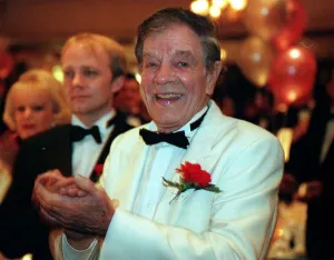 Jack Milroy comedian February 1999 White jacket bow tie red flower clapping hands Jack Milroy comedian February 1999 White jacket bow tie red flower clapping hands
