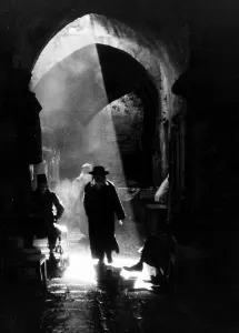 A Jewish Rabbai returning from the wailing wall through the Arab city in Old Jeruselem A Jewish Rabbai returning from the wailing wall through the Arab city in Old Jeruselem