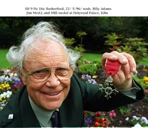 Jim Mcoll holding MBE medal at Holyrood Palace Jim Mcoll holding MBE medal at Holyrood Palace