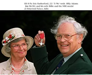 Jim McOll holding MBE medal at Holyrood Palace wife Billie looking Jim McOll holding MBE medal at Holyrood Palace wife Billie looking