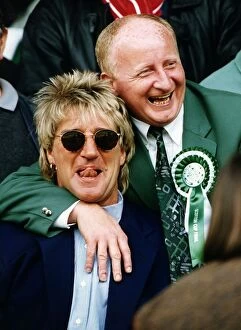 Images Dated 27th May 1995: Jimmy Johnstone footballer with arm around singer Rod Stewart smiling tongue