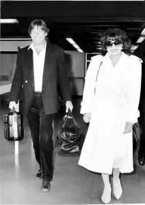 Joan Collins actress with boyfriend Bill Wiggins arriving at Heathrow Airport April Joan Collins actress with boyfriend Bill Wiggins arriving at Heathrow Airport April