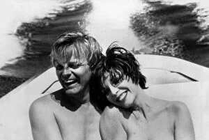 Images Dated 8th July 1985: Joan Collins actress and her fiancee Peter Holm cuddle up together on a boat trip during