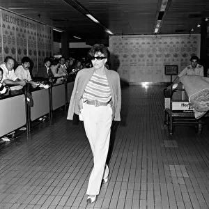 Joan Collins arriving at Heathrow from Los Angeles. 8th September 1983 Joan Collins arriving at Heathrow from Los Angeles. 8th September 1983
