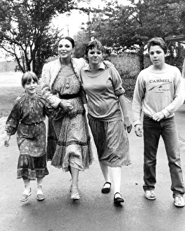 Joan Collins with children Katyana Kass, Tara Newley and Sacha Newley walking in park Joan Collins with children Katyana Kass, Tara Newley and Sacha Newley walking in park