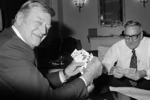John Wayne pictured relaxing playing cards in his suite at The Connaught Hotel, Mayfair John Wayne pictured relaxing playing cards in his suite at The Connaught Hotel, Mayfair