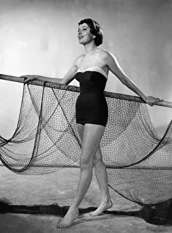 Jontzen's sleek one-piece Nylon swimsuit shows the 1951 trend for the sea shore Jontzen's sleek one-piece Nylon swimsuit shows the 1951 trend for the sea shore
