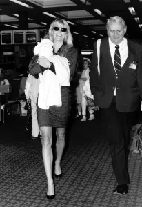 Kathy Emberg with daughter of Rod Stewart Ruby walking through Heathrow airport Kathy Emberg with daughter of Rod Stewart Ruby walking through Heathrow airport